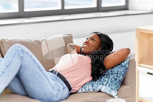 Image of happy african american young woman at home