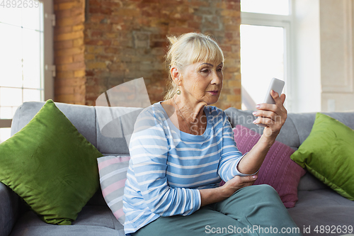 Image of Senior woman studying at home, getting online courses