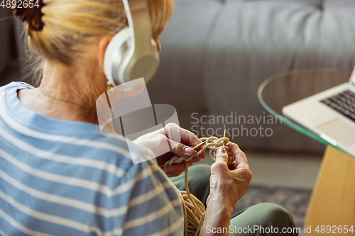 Image of Senior woman studying at home, getting online courses