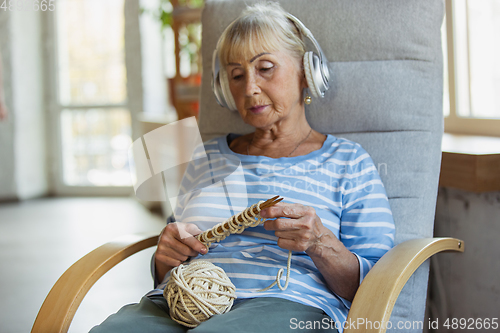 Image of Senior woman studying at home, getting online courses