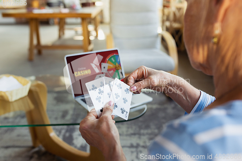 Image of Senior woman studying at home, getting online courses