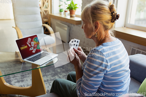 Image of Senior woman studying at home, getting online courses