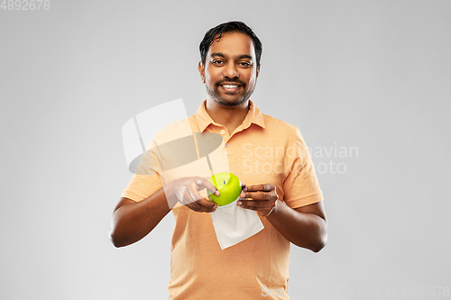 Image of indian man with apple and reusable canvas bag