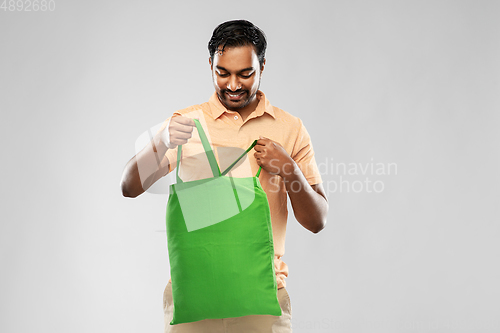 Image of man with reusable canvas bag for food shopping