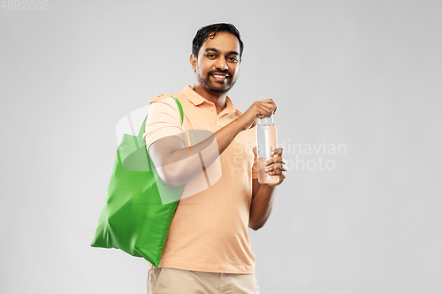 Image of man with bag for food shopping and glass bottle