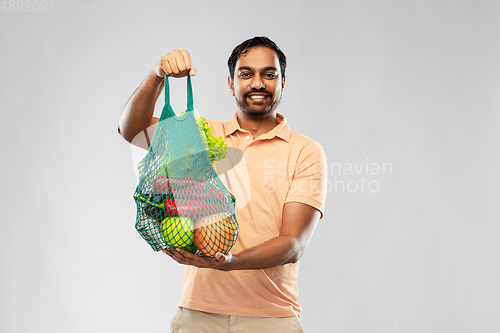 Image of happy indian man with food in reusable net tote