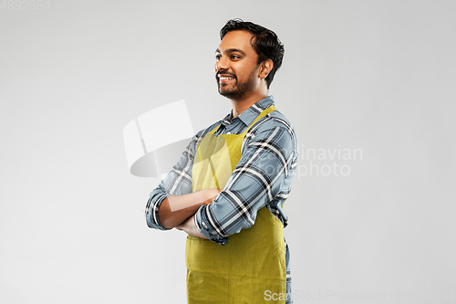 Image of happy indian male gardener or farmer in apron