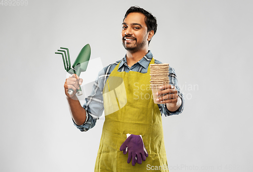 Image of indian gardener or farmer with box of garden tools