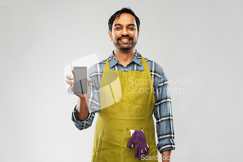 Image of indian male gardener or farmer with smartphone