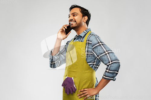 Image of indian gardener or farmer calling on smartphone