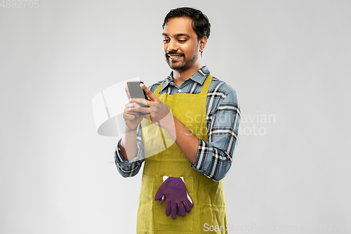 Image of indian male gardener or farmer with smartphone