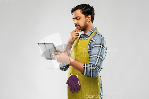 Image of indian male gardener or farmer with tablet pc