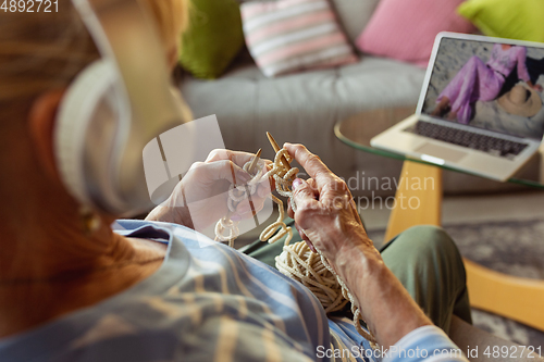 Image of Senior woman studying at home, getting online courses