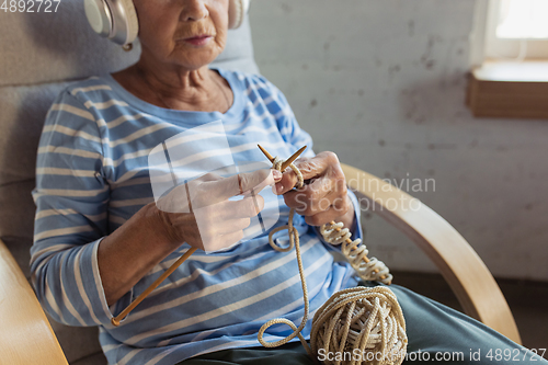 Image of Senior woman studying at home, getting online courses