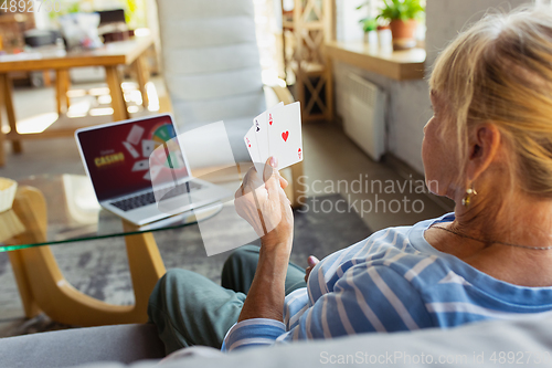 Image of Senior woman studying at home, getting online courses