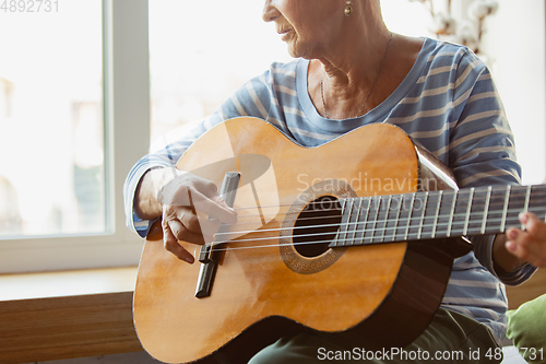 Image of Senior woman studying at home, getting online courses