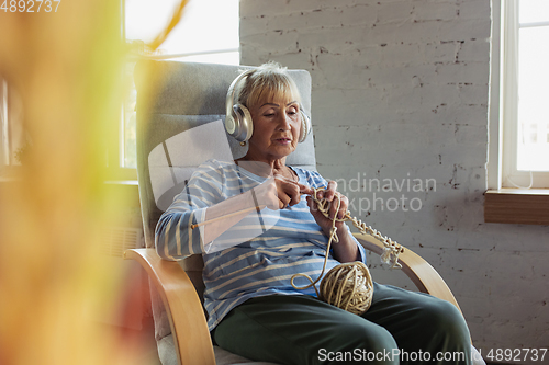 Image of Senior woman studying at home, getting online courses