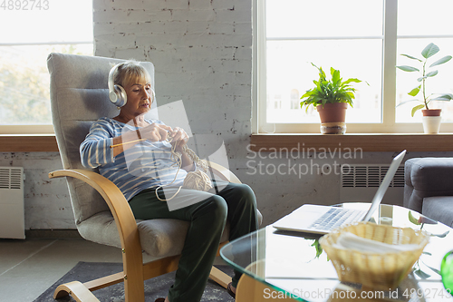 Image of Senior woman studying at home, getting online courses