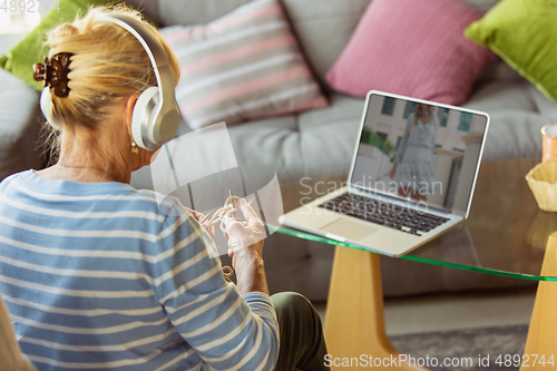 Image of Senior woman studying at home, getting online courses