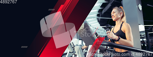 Image of Female athlete training hard in the gym. Fitness and healthy lifestyle concept. Flyer with copyspace.