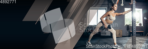 Image of Female athlete training hard in the gym. Fitness and healthy lifestyle concept. Flyer with copyspace.