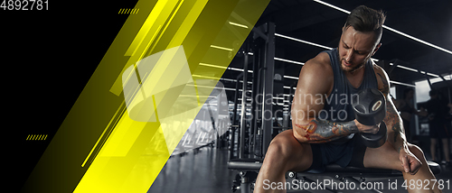 Image of The male athlete training hard in the gym. Fitness and healthy lifestyle concept. Flyer.