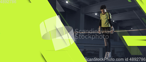 Image of Little male athlete training hard in the gym. Fitness and healthy lifestyle concept. Flyer with copyspace.