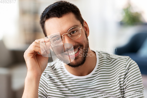 Image of portrait of happy smiling man in glasses at home