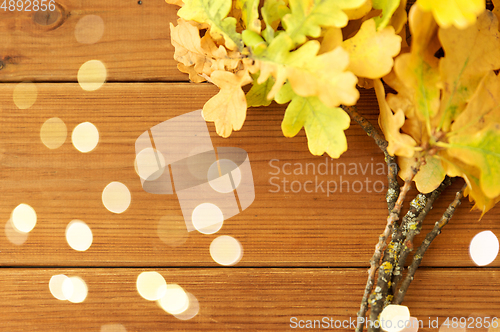 Image of oak leaves in autumn colors on wooden table
