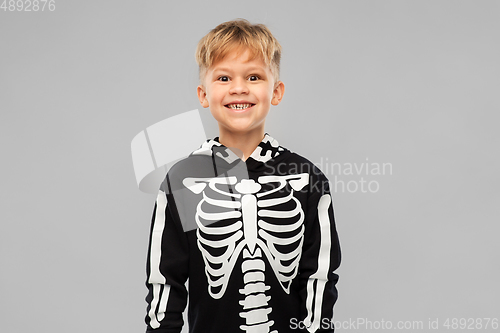 Image of boy in black halloween costume with skeleton bones