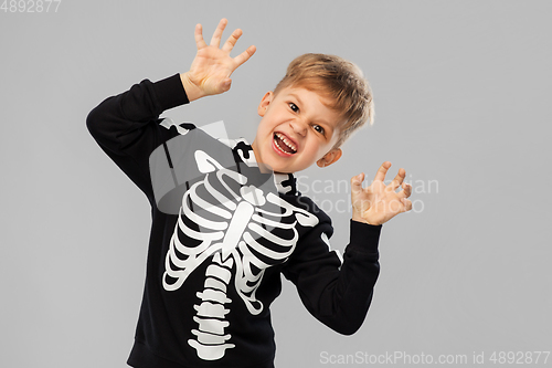 Image of boy in halloween costume of skeleton making faces