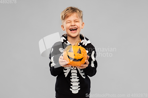 Image of happy boy in halloween costume with jack-o-lantern