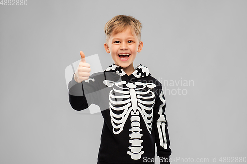 Image of boy in black halloween costume showing thumbs up