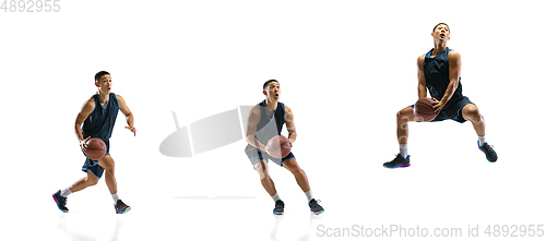 Image of Young basketball player against white studio background in motion of step-to-step goal