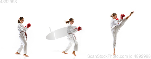 Image of Confident junior in kimono practicing taekwondo combat, martial arts