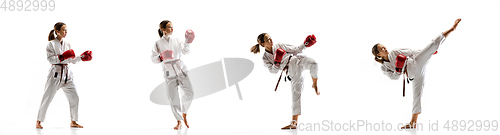 Image of Confident junior in kimono practicing taekwondo combat, martial arts