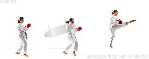 Image of Confident junior in kimono practicing taekwondo combat, martial arts