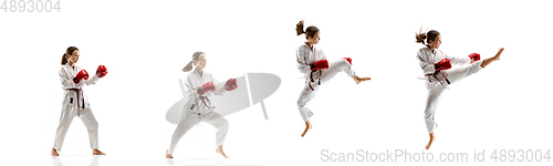 Image of Confident junior in kimono practicing taekwondo combat, martial arts