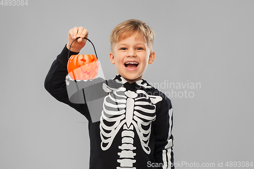 Image of happy boy in halloween costume with jack-o-lantern