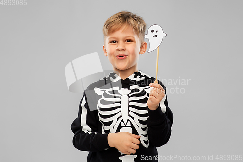 Image of boy in halloween costume with ghost decoration