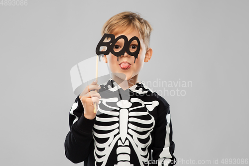 Image of boy in halloween costume of skeleton making faces