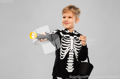 Image of happy with candies and flashlight on halloween