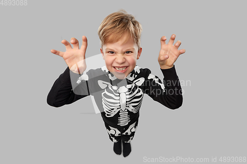 Image of boy in halloween costume of skeleton making faces