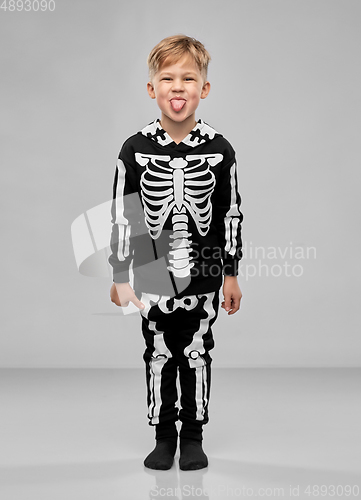 Image of boy in black halloween costume with skeleton bones