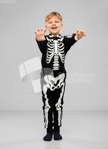 Image of boy in halloween costume of skeleton making faces