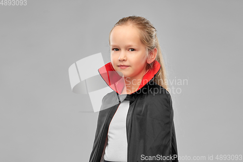 Image of girl in costume of dracula with cape on halloween