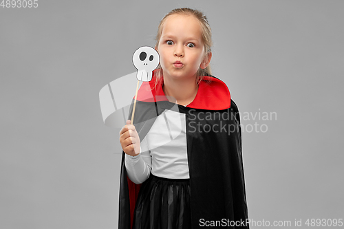 Image of girl in costume of dracula with cape on halloween