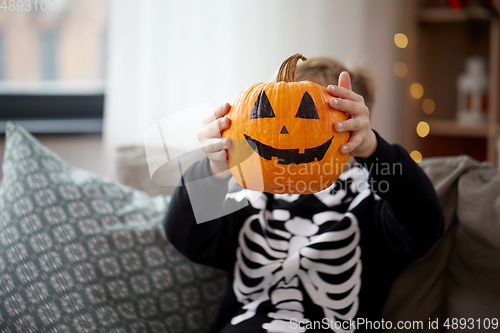 Image of boy in halloween costume with jack-o-lantern