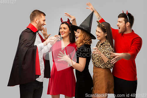 Image of friends in halloween costumes scaring each other
