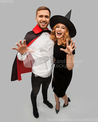 Image of couple in halloween costumes of witch and vampire